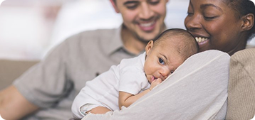 Baby having cuddles with mother and father figure