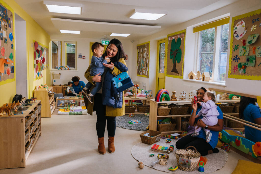 mother figure picking child up from nursery