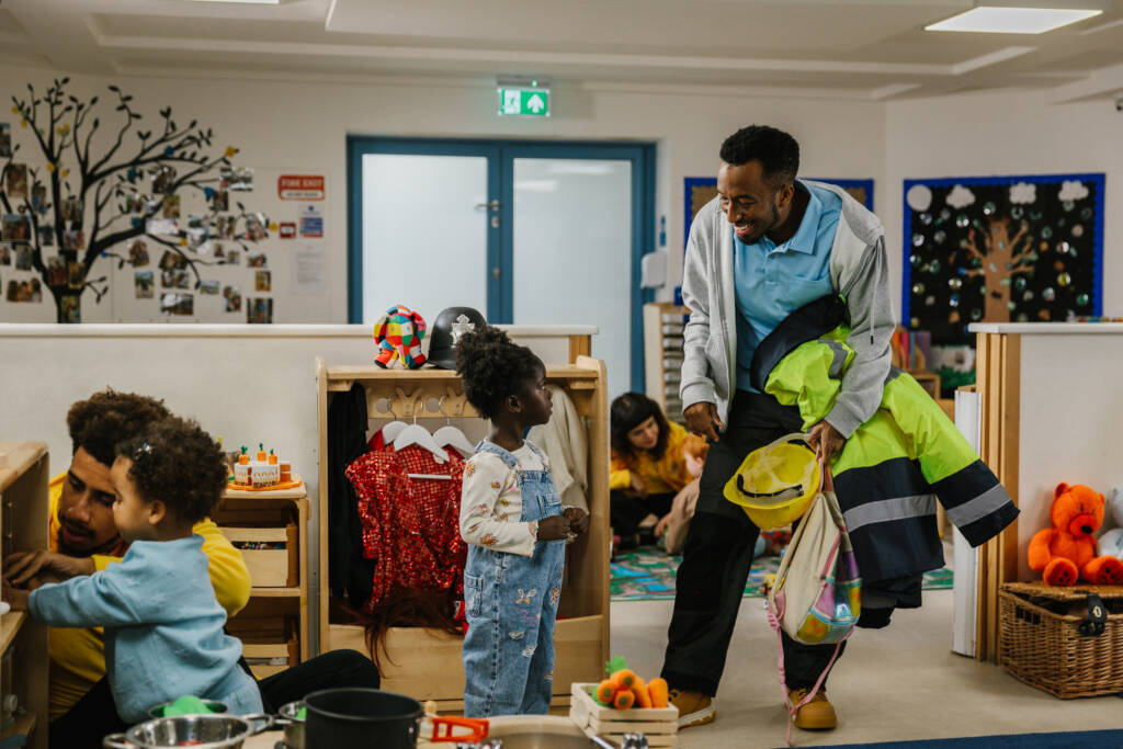 Father figure picking up daughter