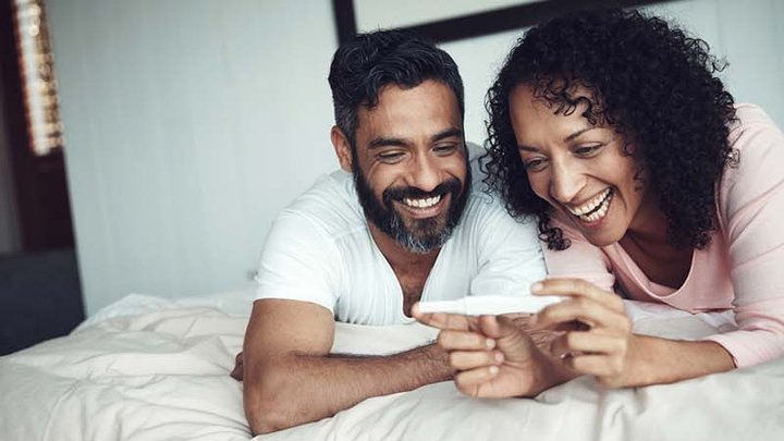 New parents looking at pregnancy excitedly