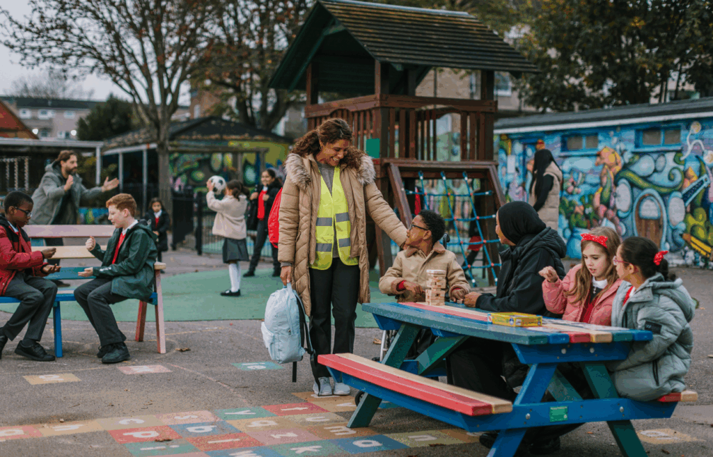 Mother figure picking boy up from nursery