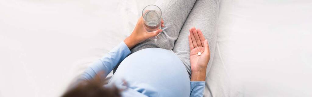 Pregnant lady taking vitamins