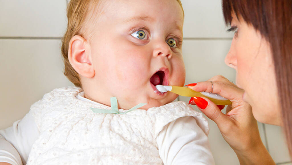 Baby and mum brushing teeth
