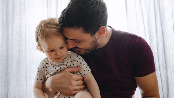 Dad and baby cuddling