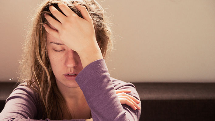 Lady with head in hands