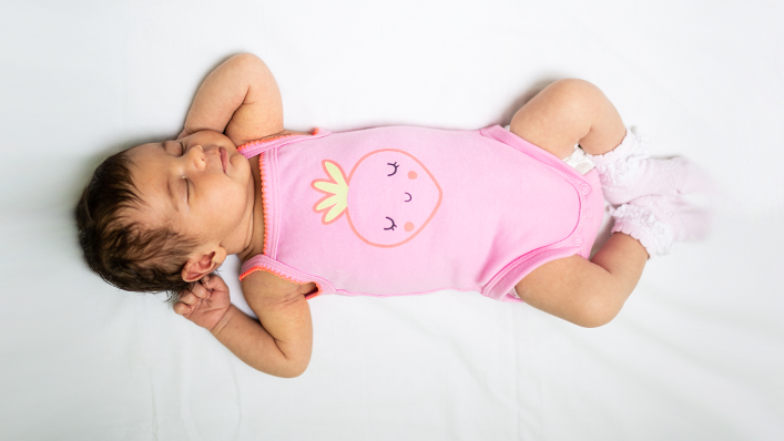 A sleeping baby, lying on her back