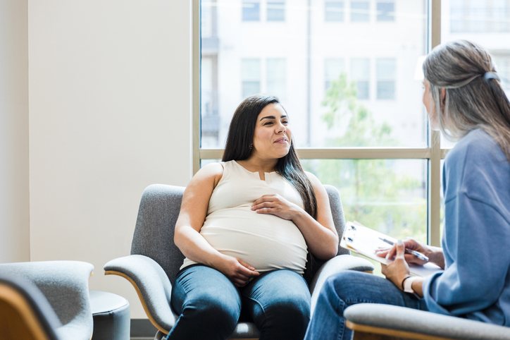 Pregnant woman talking with a healthcare professional